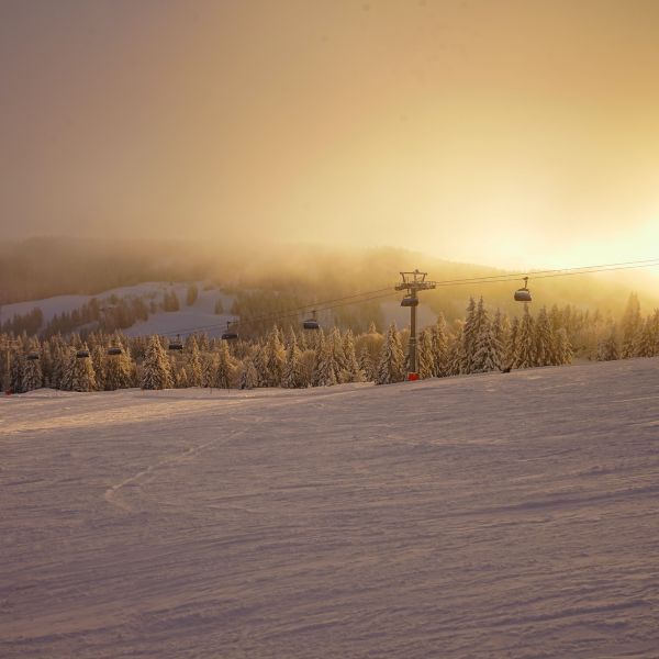 View of ski lift and snow-covered hills at Feldberg, Germany at sunrise