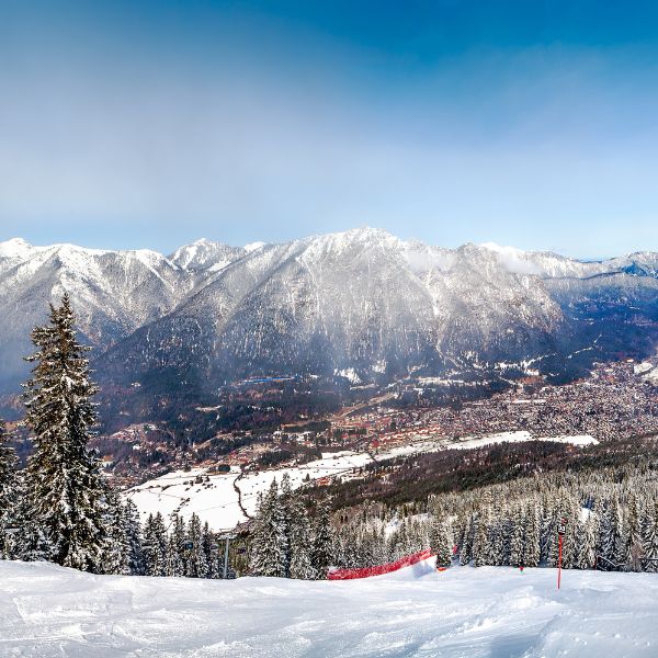 View of Garmisch-Partenkirchen ski resort in Germany from a snow-topped mountain