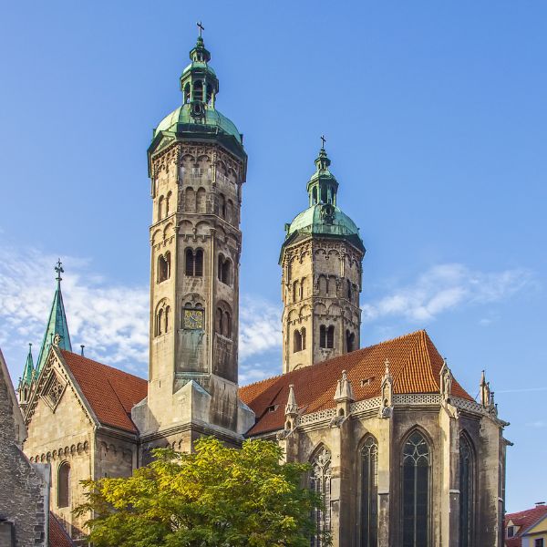 Naumburg Cathedral, Germany: grey building with twin copper-topped spires and red tile roof