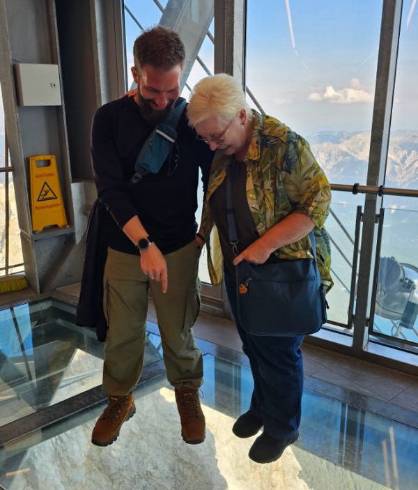 Eran & Gerhild standing on glass floor at the top of the Zugspitze!