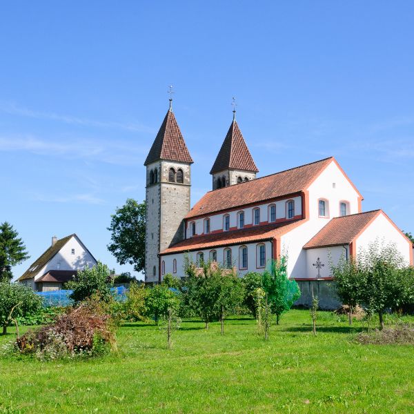 Twin-tower red roof church surrounded by green grass: Church of St. Peter and Paul in Germany