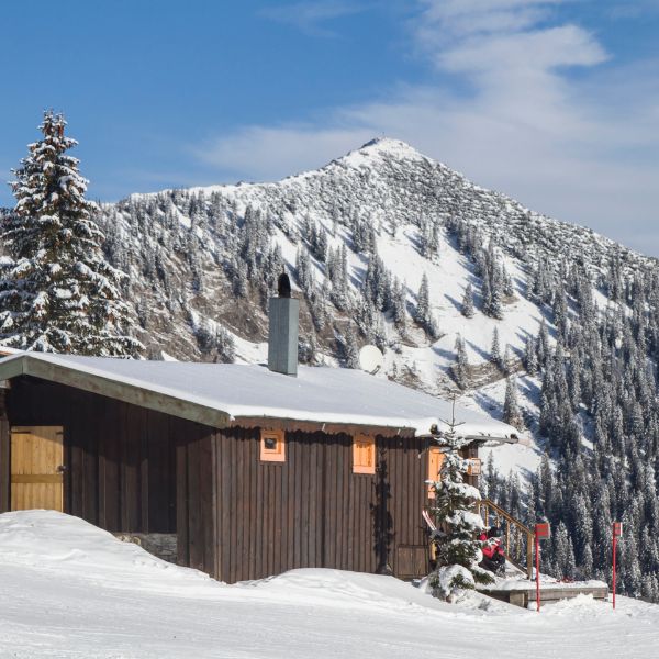 Wood ski chalet on snow-covered mountain at Spitzingsee, Germany