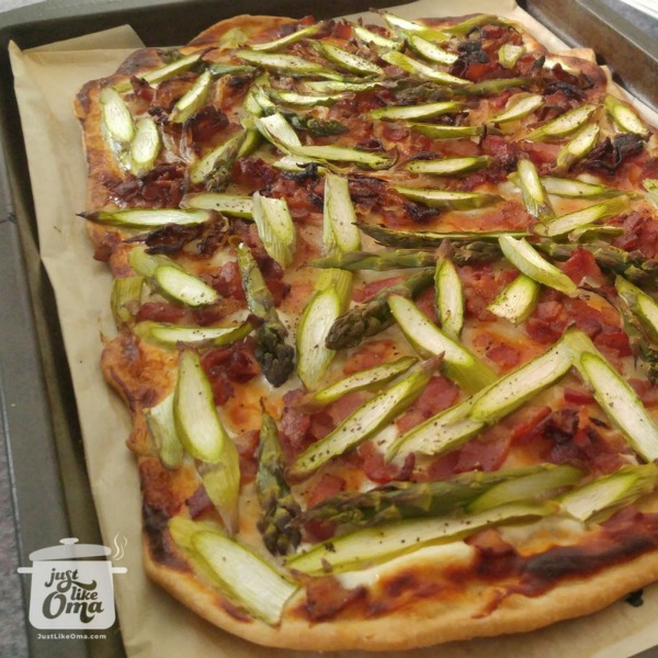 Flammkuchen with caramelized onions, bacon and sliced asparagus